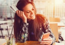 Young women in a cafe with credit card +++++ Note for the inspector : Credit card is fake +++++